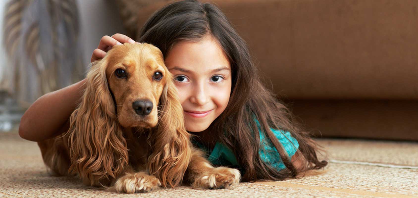 Girl and dog on carpet