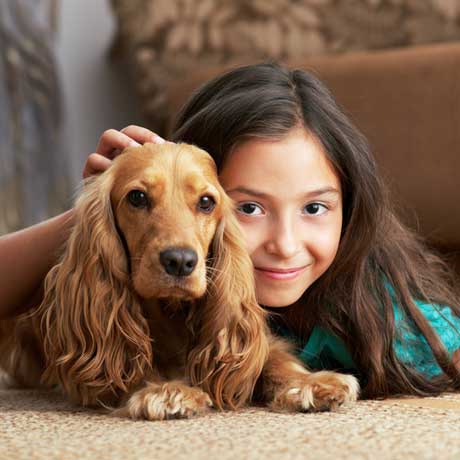Girl and dog on carpet